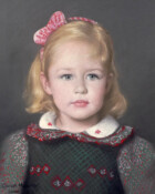 A young girl with a red and white ribbon